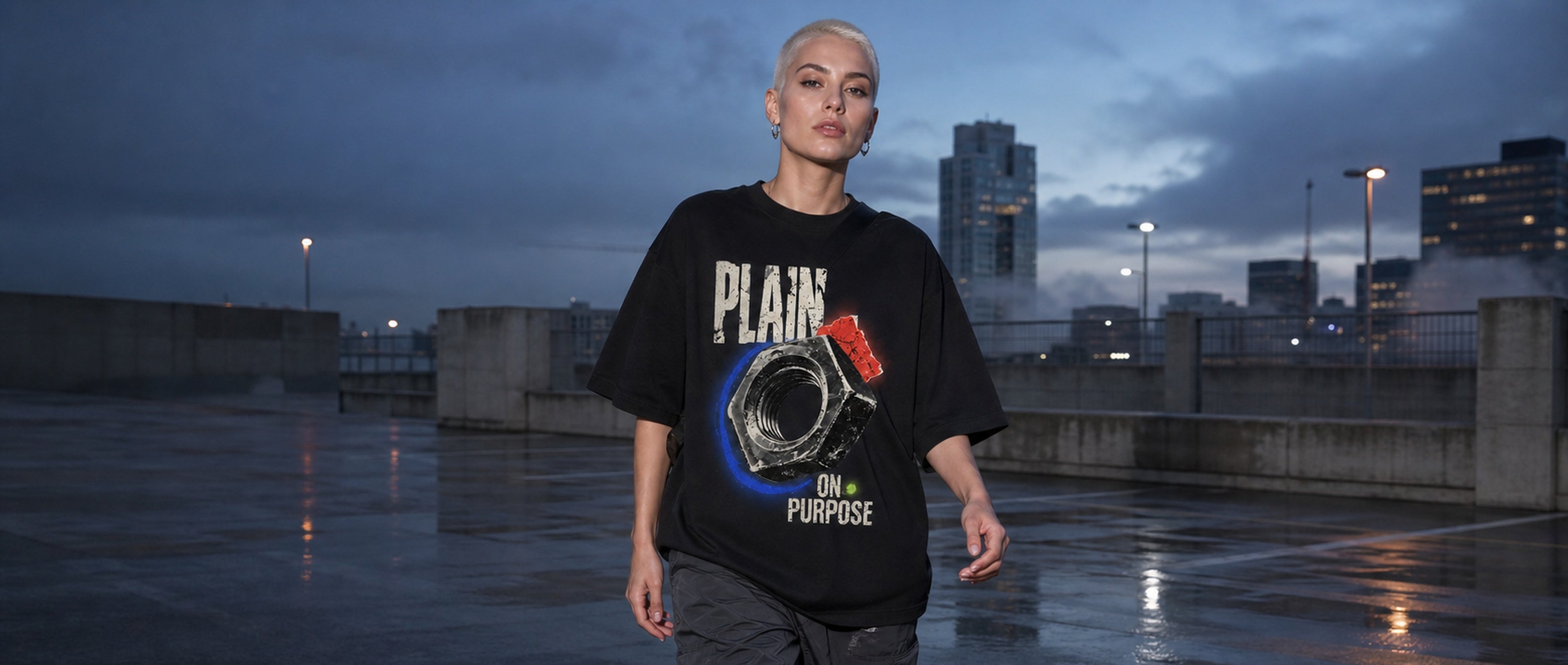 Adult model wearing the 3o1d PLAIN ON PURPOSE oversized T-shirt in Black on a rain-wet city rooftop.