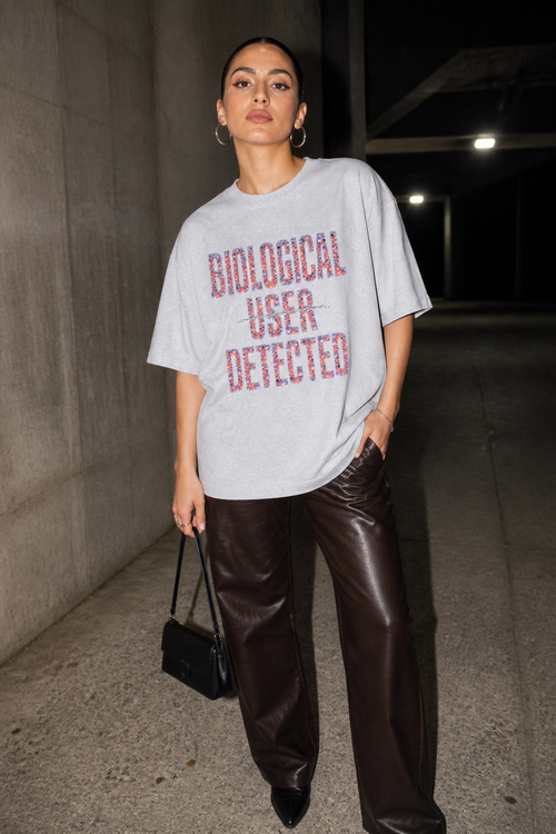 Model wearing the 3o1d BIOLOGICAL USER DETECTED oversized T-shirt in Cool Heather Grey, front graphic.