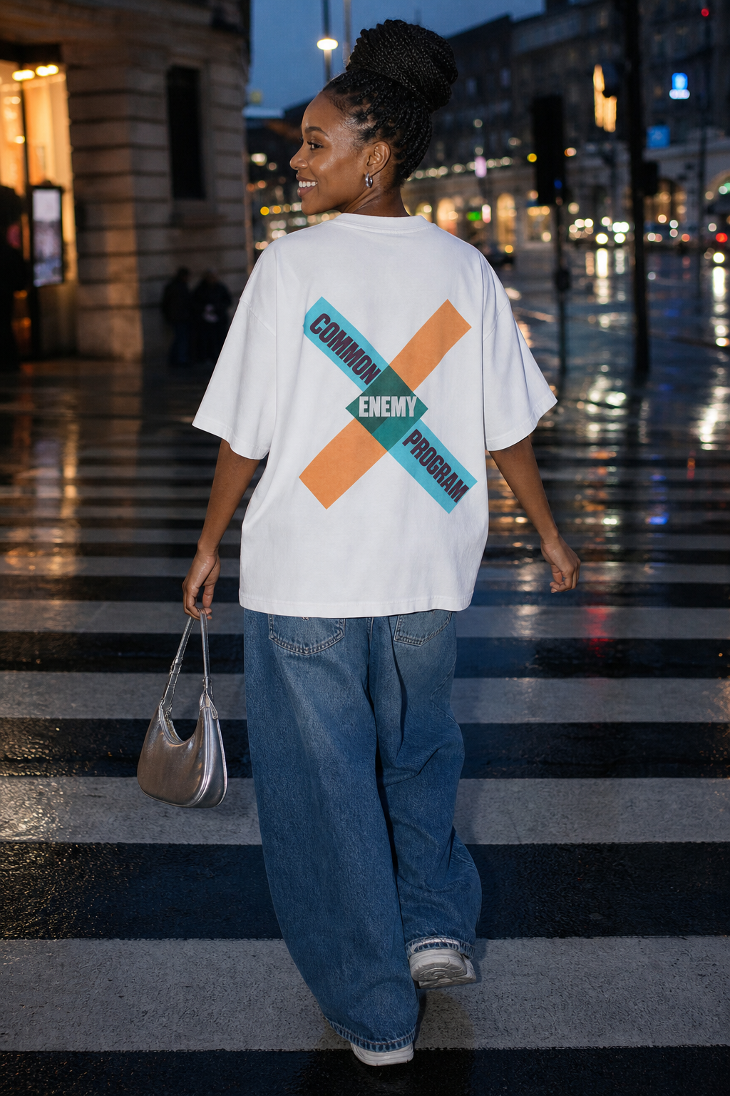 Model wearing the 3o1d COMMON ENEMY PROGRAM oversized T-shirt in White, back graphic.