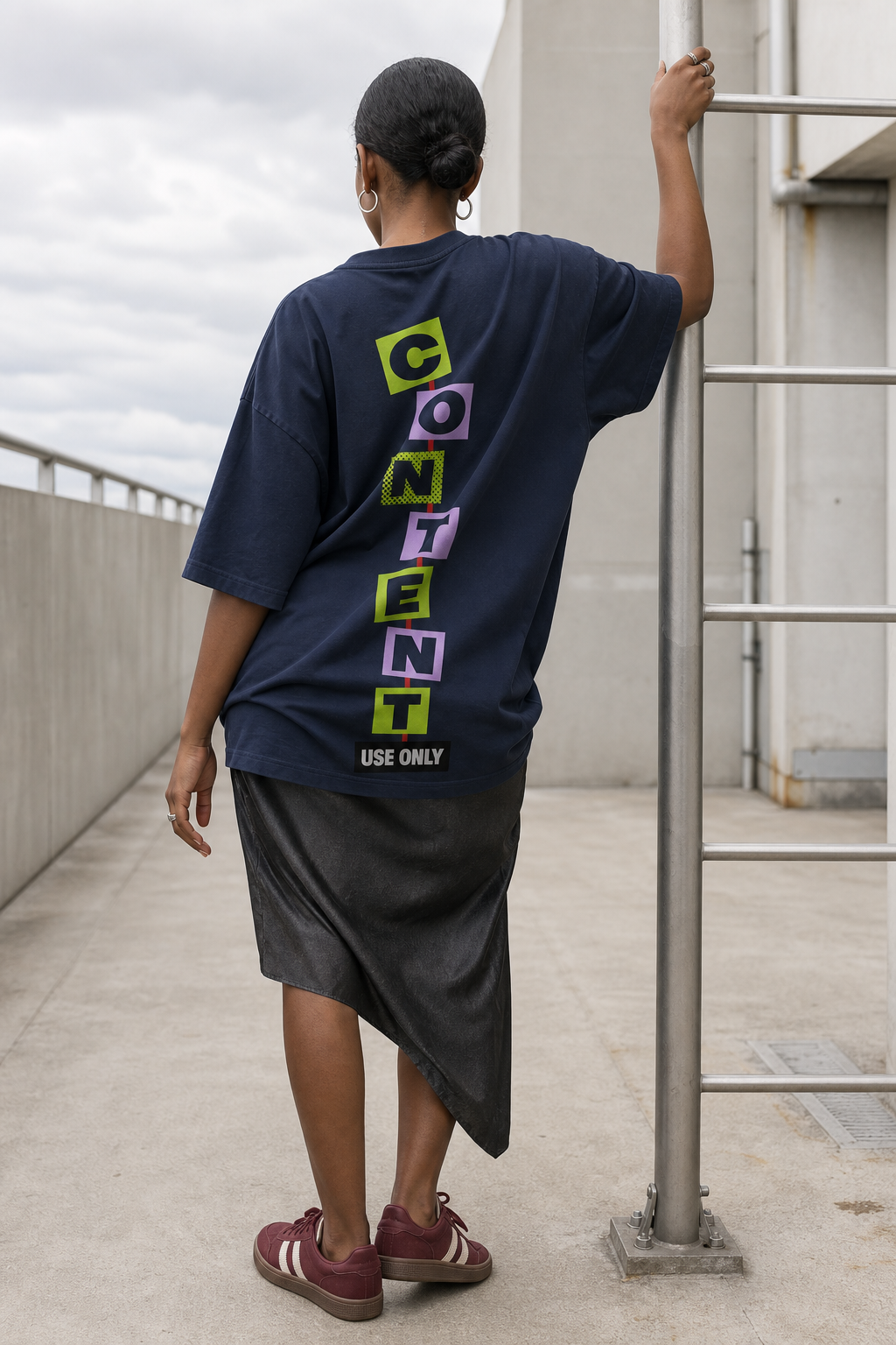 Model wearing the 3o1d CONTENT USE ONLY oversized T-shirt in French Navy, back graphic.