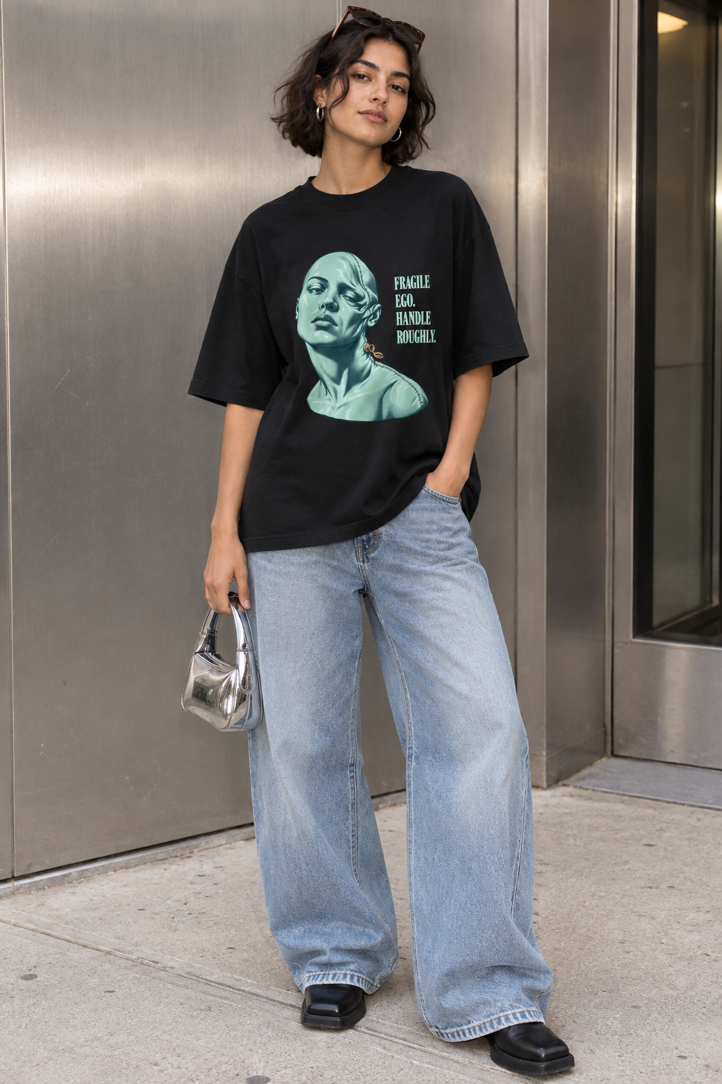 Model wearing the 3o1d FRAGILE EGO. HANDLE ROUGHLY. oversized T-shirt in Black, front graphic.