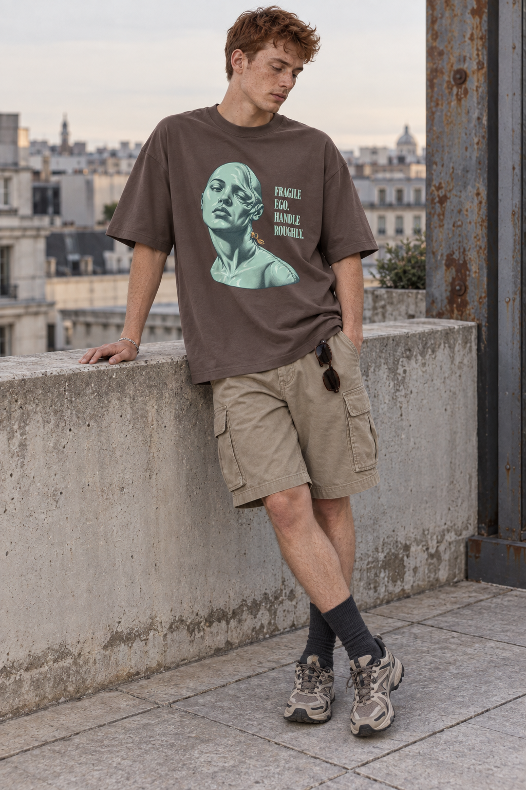 Model wearing the 3o1d FRAGILE EGO. HANDLE ROUGHLY. oversized T-shirt in Mocha, front graphic.