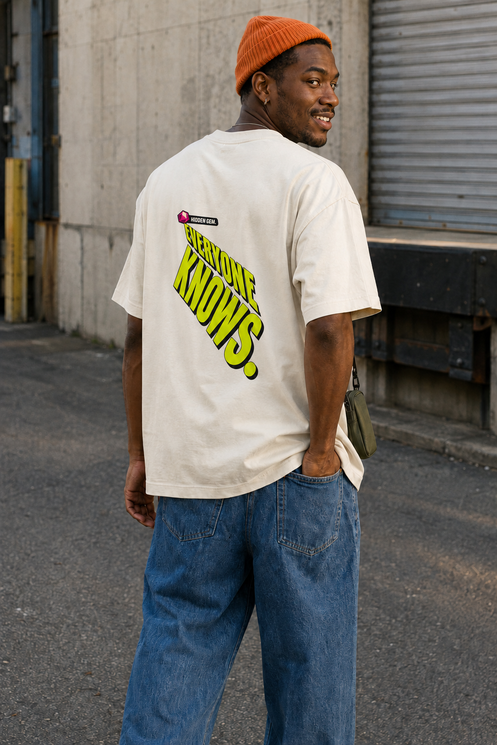 Model wearing the 3o1d HIDDEN GEM. EVERYONE KNOWS. oversized T-shirt in Cream, back graphic.