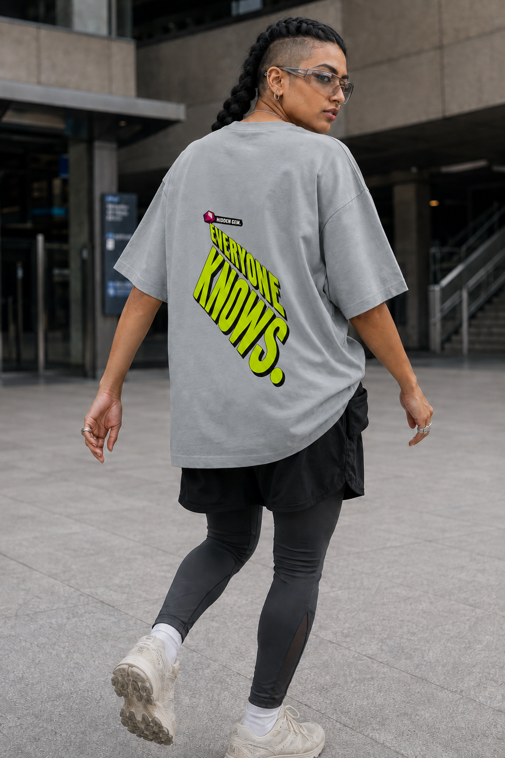Model wearing the 3o1d HIDDEN GEM. EVERYONE KNOWS. oversized T-shirt in Misty Grey, back graphic.