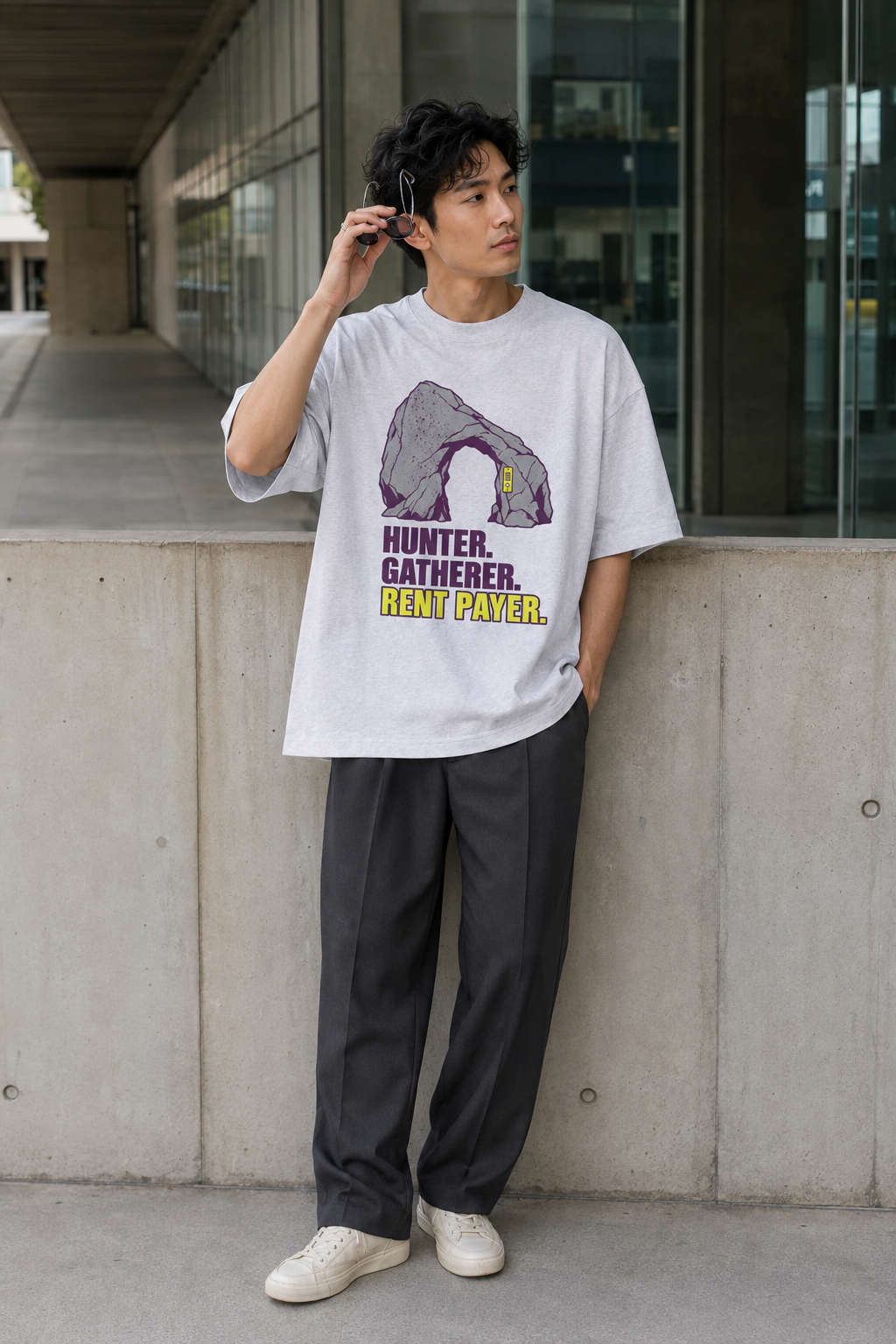 Model wearing the 3o1d HUNTER. GATHERER. RENT PAYER. oversized T-shirt in Cool Heather Grey, front graphic.