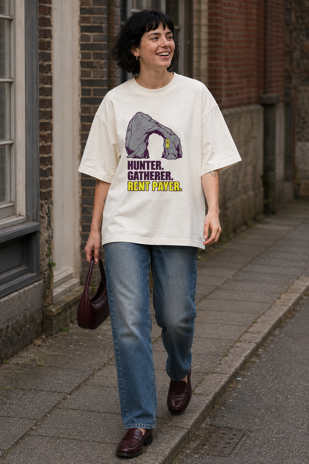 Model wearing the 3o1d HUNTER. GATHERER. RENT PAYER. oversized T-shirt in Cream, front graphic.