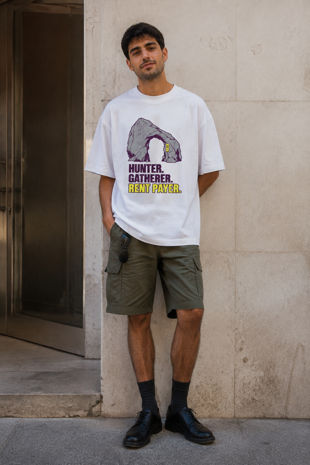 Model wearing the 3o1d HUNTER. GATHERER. RENT PAYER. oversized T-shirt in White, front graphic.