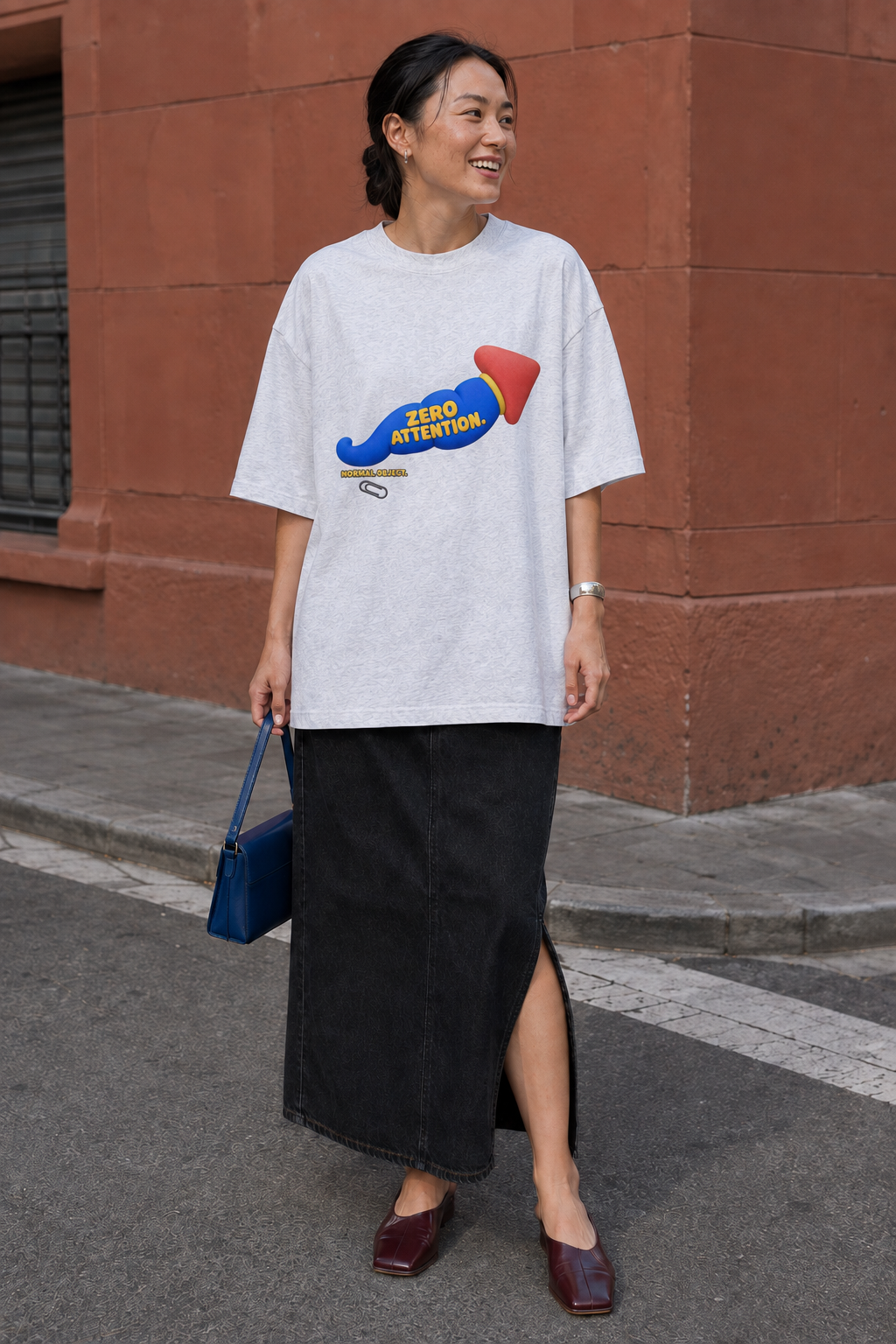 Model wearing the 3o1d NORMAL OBJECT. ZERO ATTENTION. oversized T-shirt in Cool Heather Grey, front graphic.