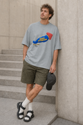 Model wearing the 3o1d NORMAL OBJECT. ZERO ATTENTION. oversized T-shirt in Misty Grey, front graphic.