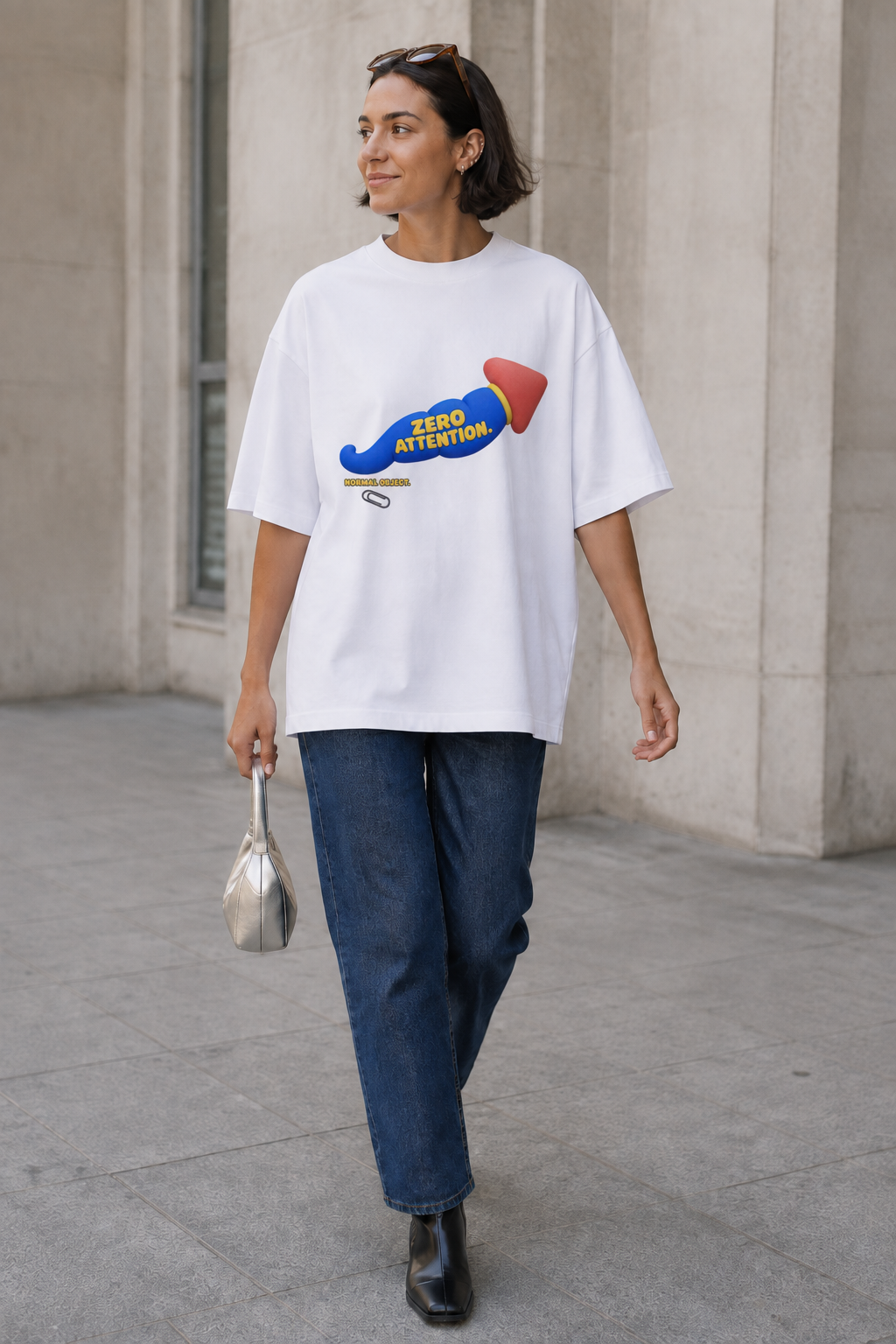 Model wearing the 3o1d NORMAL OBJECT. ZERO ATTENTION. oversized T-shirt in White, front graphic.