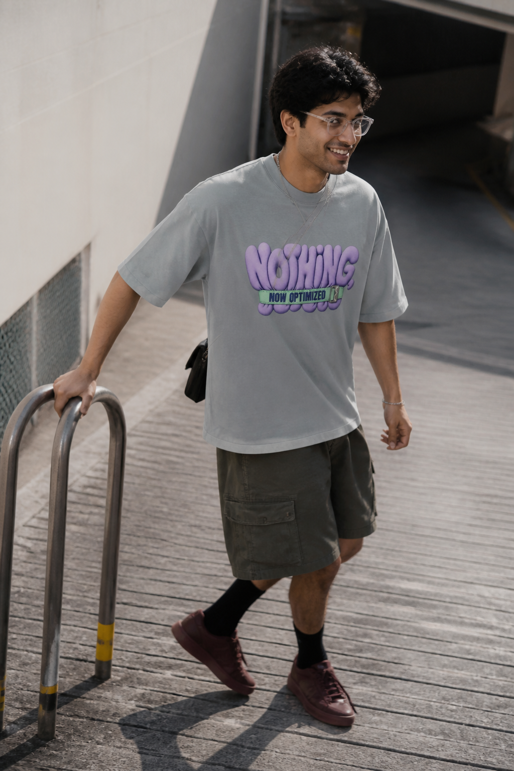 Model wearing the 3o1d NOTHING, NOW OPTIMIZED oversized T-shirt in Misty Grey, front graphic.