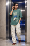 Model wearing the 3o1d PRICED TO YOUR LIMIT oversized T-shirt in Green Bay, front graphic.