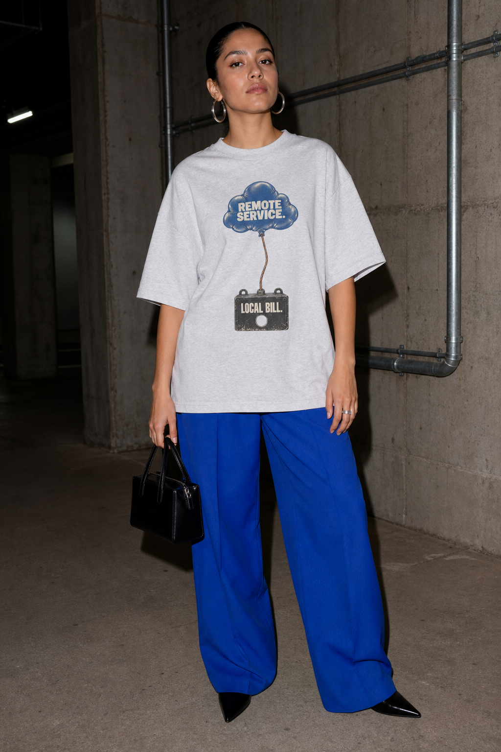 Model wearing the 3o1d REMOTE SERVICE. LOCAL BILL. oversized T-shirt in Cool Heather Grey, front graphic.
