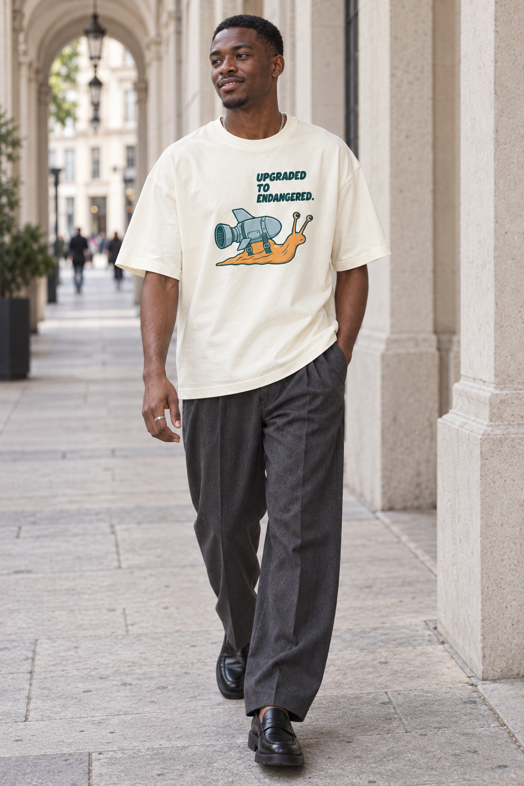 Model wearing the 3o1d UPGRADED TO ENDANGERED. oversized T-shirt in Cream, front graphic.