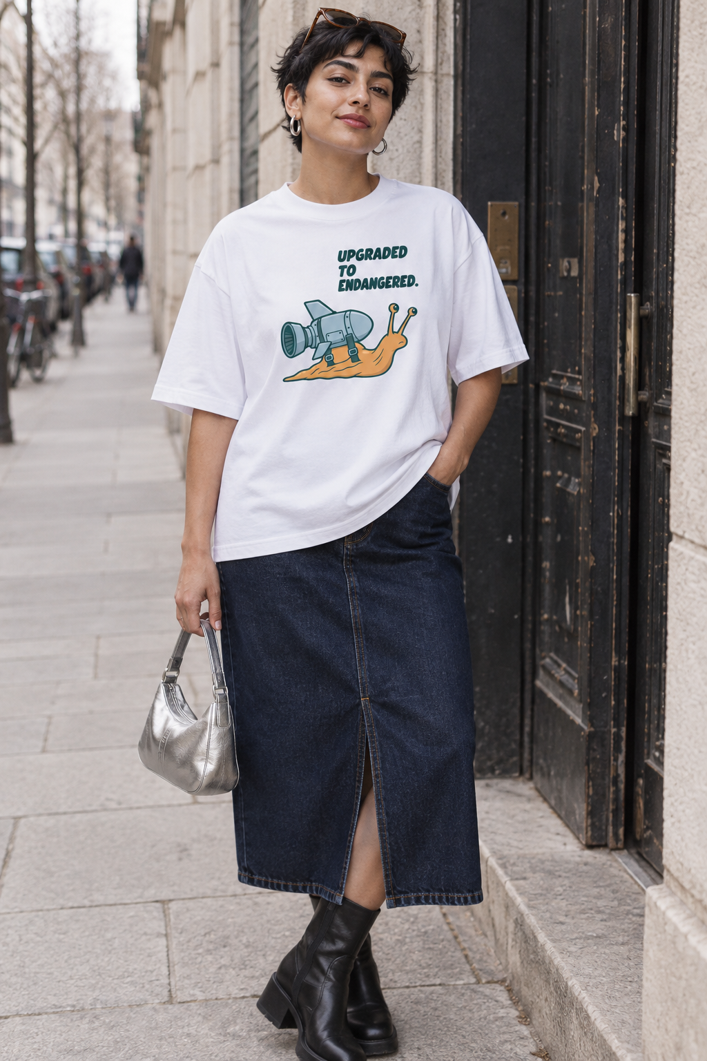 Model wearing the 3o1d UPGRADED TO ENDANGERED. oversized T-shirt in White, front graphic.