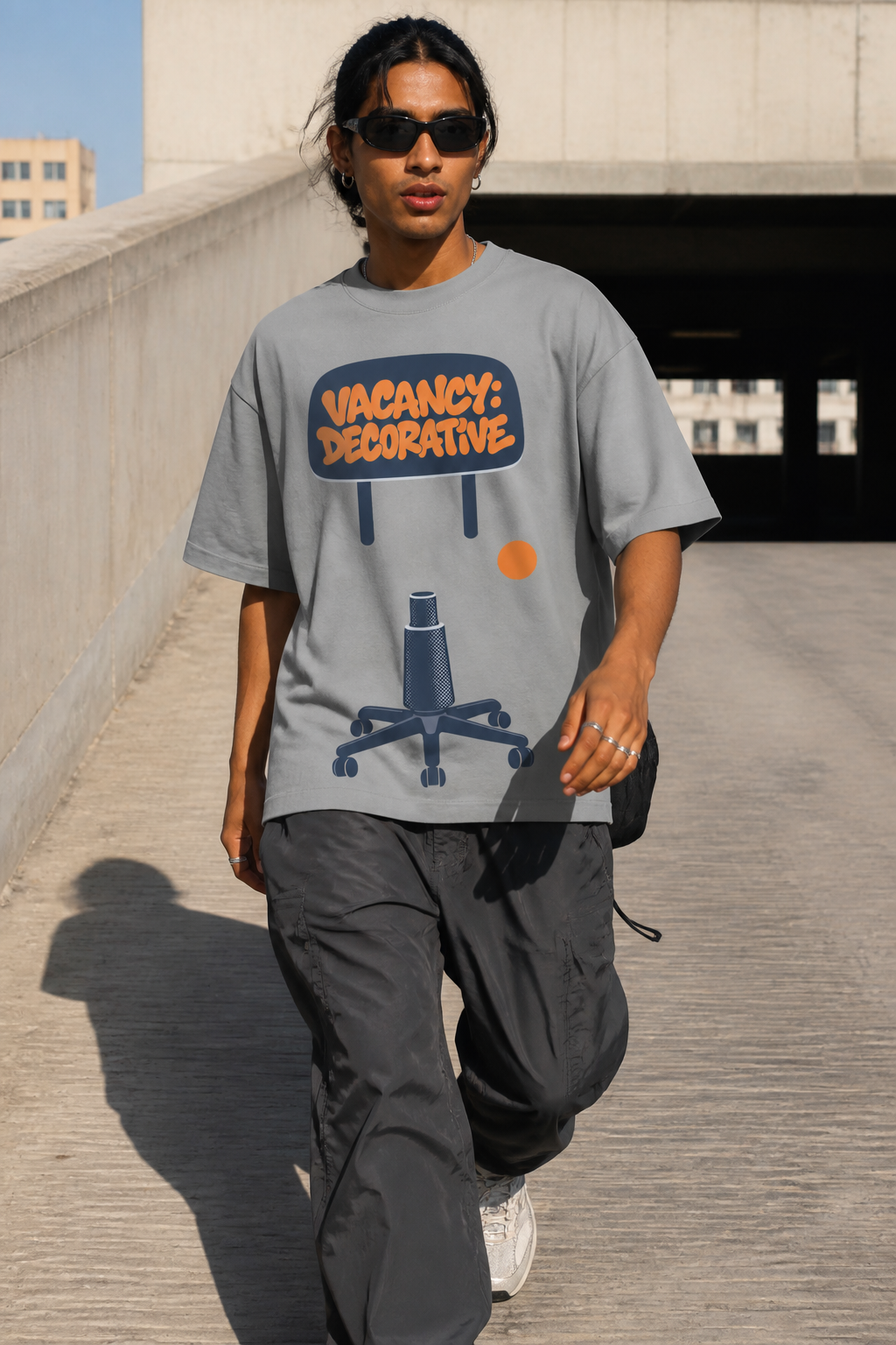 Model wearing the 3o1d VACANCY: DECORATIVE oversized T-shirt in Misty Grey, front graphic.